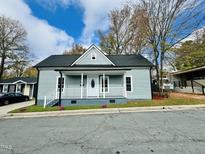 Charming single-story home featuring a welcoming front porch and nicely landscaped front yard at 425 Price Ave, Durham, NC 27707