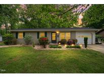 Charming one-story home with landscaped front yard, flowerbeds, and a one car garage at 509 Stokes Rd, Graham, NC 27253