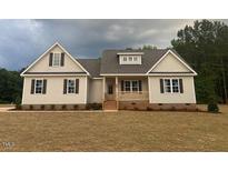 Charming single-story home with a welcoming front porch and well-manicured lawn in a serene neighborhood at 529 Mulberry Rd, Spring Hope, NC 27882