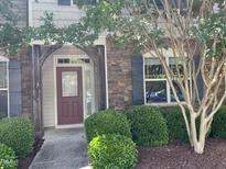 Charming front entrance with a red door, stone accents, and manicured landscaping at 532 Matheson Pl, Cary, NC 27511