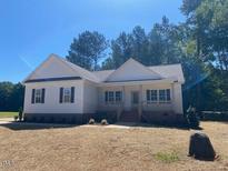 Charming single-story home with white siding, black shutters, and a welcoming front porch at 539 Mulberry Rd, Spring Hope, NC 27882