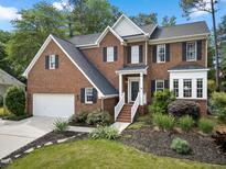Charming brick home with manicured landscaping and inviting front entrance at 6 Beltre Ct, Durham, NC 27705