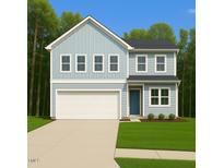 Charming two-story home with a light blue exterior, attached garage, and well-manicured lawn at 633 Conover Rd, Durham, NC 27703