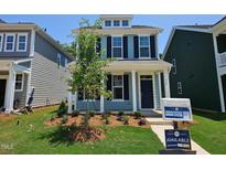 Charming two-story home with blue siding, black shutters, and a well-manicured front yard at 736 Georgias Landing Pkwy # 7, Raleigh, NC 27603