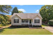 Charming single-story home with a well-manicured lawn and inviting front porch at 765 S Hollybrook Rd, Wendell, NC 27591