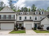 Charming townhome exteriors feature attached garages, landscaped yards, and inviting entryways at 80 Willow Green Dr, Clayton, NC 27527