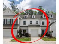 Charming townhome featuring a one car garage, dormer windows, and a well-manicured lawn at 80 Willow Green Dr, Clayton, NC 27527