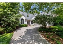 Stunning single-story home with beautiful landscaping and a long driveway shaded by mature trees at 81502 Alexander, Chapel Hill, NC 27517
