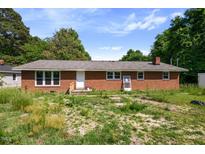 Charming one-story brick home with a classic design and ample natural light through the front windows at 995 Shawtown Rd, Lillington, NC 27546