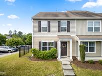 Charming townhome showcasing a well-maintained lawn, neutral siding, and inviting front entrance at 100 Stratford Lakes Dr # 361, Durham, NC 27713