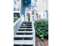 Inviting front entrance with wooden steps and blue siding creates a warm welcome to this home at 109 Virginia Pl, Cary, NC 27513