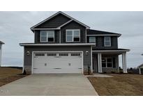 Charming two-story home with a wide driveway and a two-car garage at 111 High Hampton Way, Fuquay Varina, NC 27526