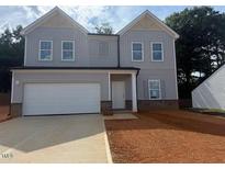 Charming two-story home with gray siding, a two-car garage, and a neatly landscaped front yard at 11121 Salers Loop, Middlesex, NC 27557
