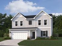 Charming two-story home with a two-car garage, manicured lawn, and classic architectural details at 11121 Salers Loop, Middlesex, NC 27557