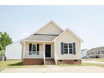 Charming single-story home with a cozy front porch and well-maintained lawn on a sunny day at 12 Linsey Ct, Lillington, NC 27546