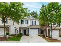 Charming two-story home with a well-manicured lawn, attached garage, and inviting curb appeal at 1231 Silver Beach Way, Raleigh, NC 27606