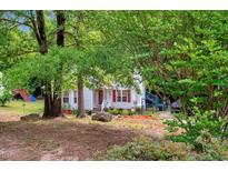 Charming two-story home with landscaped yard and mature trees offering privacy at 135 Crooked Creek Run, Louisburg, NC 27549