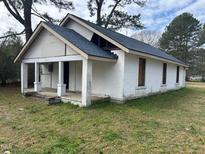 Exterior view of a white one-story home with a blue roof and a covered front porch at 1400 Hargrove St, Rocky Mount, NC 27801