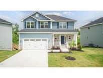 Charming two-story home with blue siding, a gray roof, and a well-manicured lawn, creating an inviting curb appeal at 279 Hopewell Branch Ct, Smithfield, NC 27577
