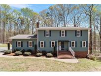 Charming two-story home with a brick staircase and manicured landscaping at 3418 Carriage Trl, Hillsborough, NC 27278