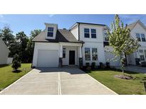Beautiful new construction home featuring a modern design with white siding and a well-manicured lawn at 367 Whitley Ridge Dr, Clayton, NC 27527
