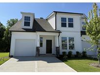 Charming new construction home with white siding, black accents, and an attached two-car garage at 367 Whitley Ridge Dr, Clayton, NC 27527