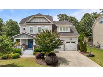 Beautiful two-story home with manicured lawn, two-car garage, and a classic craftsman-style front porch at 4562 Brighton Ridge Dr, Apex, NC 27539