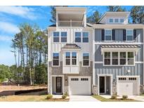 Stunning new townhome featuring stone accents, a balcony and a two-car garage at 509 Sherron Rd # 11, Durham, NC 27703