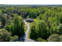 Beautiful single-story home with a long driveway surrounded by mature trees at 5912 Mt Zion Rd, Snow Camp, NC 27349