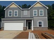 Charming two-story home with gray siding, a two-car garage, and a well-manicured lawn at 6828 Galloway Dr, Middlesex, NC 27557