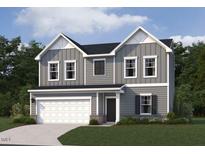 Charming two-story home with gray siding, white trim, and a two-car garage on a well manicured lawn at 6828 Galloway Dr, Middlesex, NC 27557