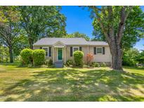 Charming single-story home featuring a well-manicured lawn and mature trees at 701 Veterans Dr, Elon, NC 27244