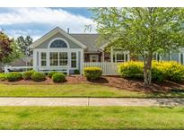 Charming home featuring a well-manicured lawn, tidy landscaping, and a quaint white picket fence at 924 Carolina Bell Rd, Apex, NC 27502