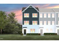 Charming townhome showcasing a modern design and inviting front entrance and manicured lawn at 1482 Hasse Ave, Apex, NC 27502