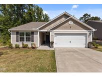 Charming single-story home featuring a well-maintained lawn and a two-car garage at 1574 Dorsett Ln, Creedmoor, NC 27522