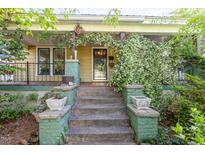 Charming home featuring a welcoming front porch with flowering vines and a decorative sun ornament at 206 N State St, Raleigh, NC 27601