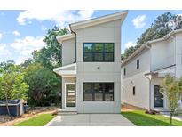 Contemporary two-story home showcasing clean lines and modern architectural design with a well-manicured lawn at 2205 Tampa Ave, Durham, NC 27705