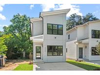 Modern two-story home with a gray facade, black-framed windows, and a well-manicured front lawn at 2205 Tampa Ave, Durham, NC 27705