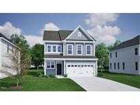 Charming two-story home featuring a light gray exterior, a two-car garage, and a well-maintained lawn at 260 Meadowbark Bnd # 44, Garner, NC 27529