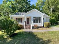 Charming single-story home featuring a welcoming front porch, brick stairs, and well-maintained landscaping at 2747 Michelle Ct, Creedmoor, NC 27522