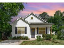 Charming home showcasing a well-manicured lawn and white siding at 303 Godwin St, Selma, NC 27576