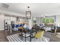 Bright open-concept living area featuring modern decor, stainless steel appliances, and lots of natural light at 327 Augusta Pond Way # 172, Raleigh, NC 27603