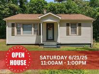 Charming single-story home with manicured lawn and inviting curb appeal and OPEN HOUSE sign visible at 3899 Warrenton Rd, Henderson, NC 27537