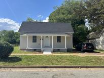 Charming single-story home with covered front porch and freshly manicured lawn at 409 S Flanner St St, Burlington, NC 27215