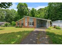 Charming single-story home featuring a combination of brick and siding, complemented by a well-maintained front yard at 5652 Laurel Crest Dr, Durham, NC 27712