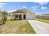 Charming single-story home featuring a well-manicured lawn and a convenient one-car garage at 165 Bywood Dr, Roxboro, NC 27573