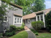 Charming gray two-story home featuring a walkway and mature landscaping at 1707 Falls Church Rd, Raleigh, NC 27609