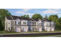 New townhome row featuring a stone facade, attached garages, and neutral-colored siding at 1907 Hinesley Dr, Durham, NC 27703