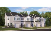 New townhouse construction features a stone facade and attached garage at 1915 Hinesley Dr, Durham, NC 27703