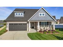 Beautiful two-story home featuring a well-manicured lawn, covered porch, and a two car garage at 2096 Dowell Ct, Burlington, NC 27215